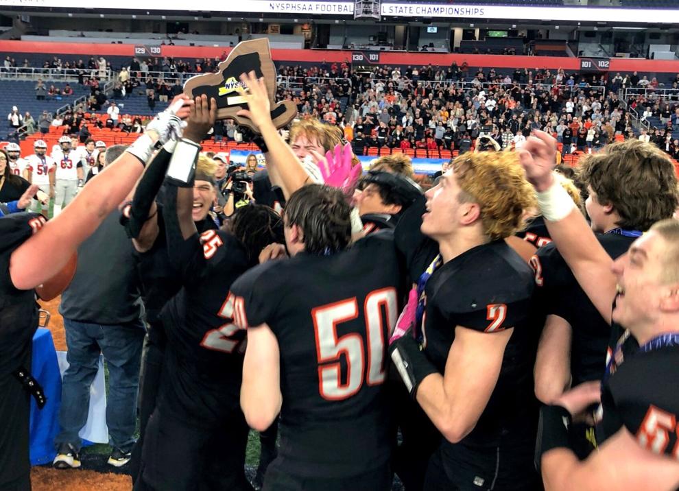 Varsity football team players celebrate the 2024 Class C state win