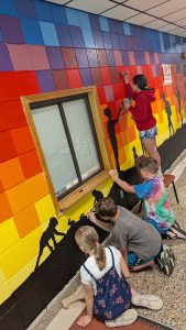 Students working on the elementary school mural
