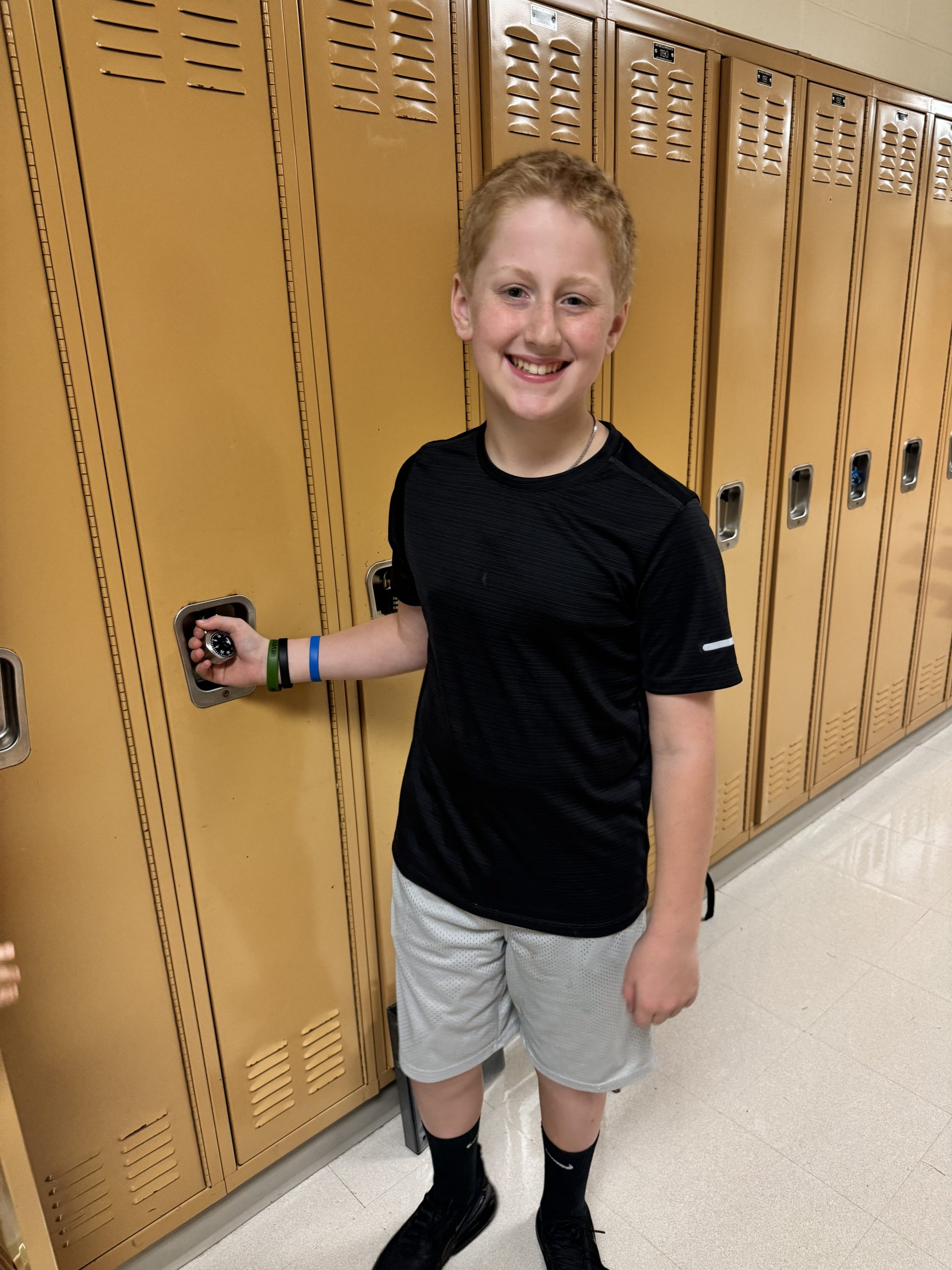 A student stands at his locker in the middle school