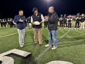 Dr. Ryan Sherman and James Ducharme present John Bowen with his 100th ball.