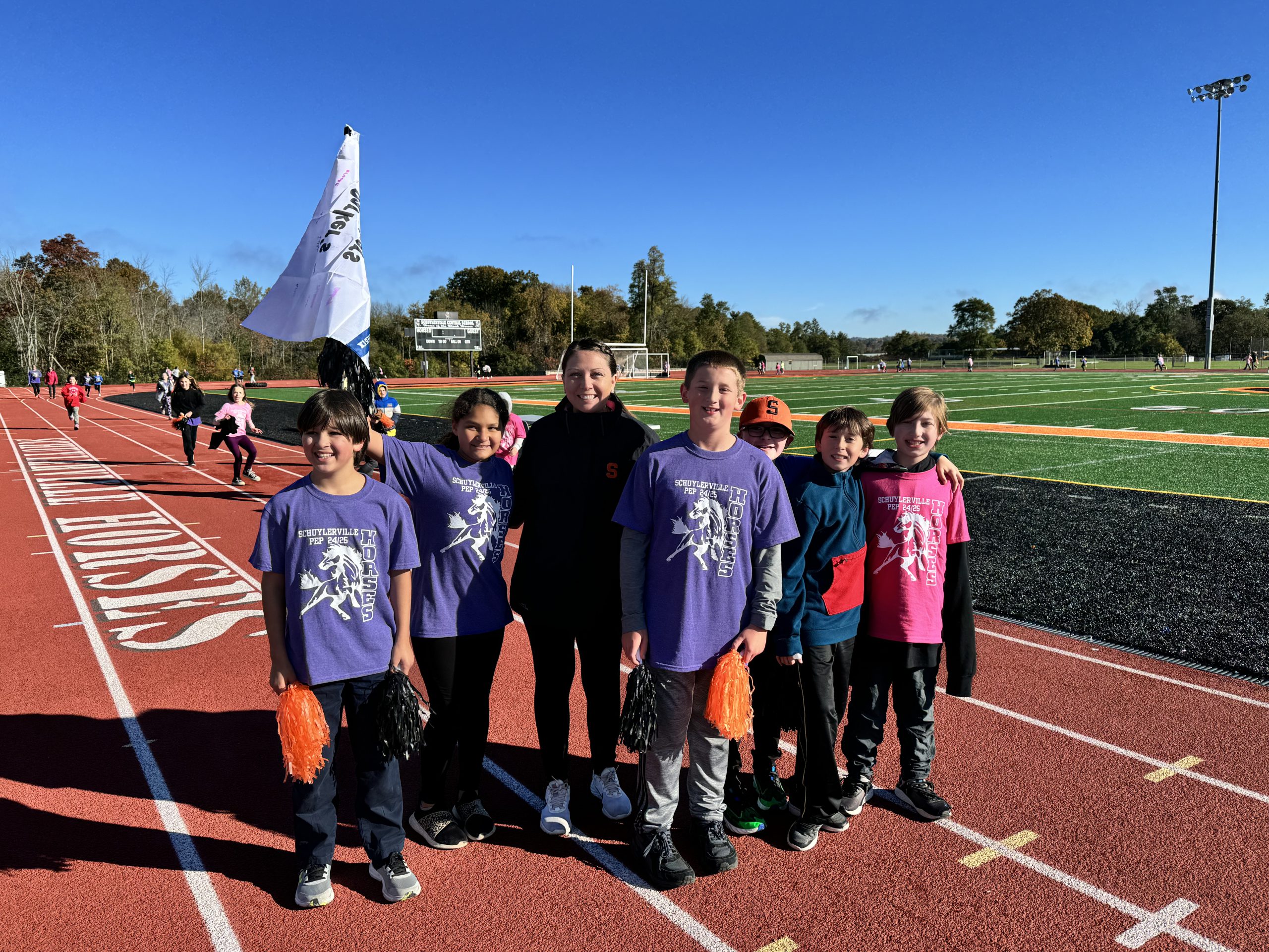 Elementary Principal Stacy Marzullo with students during the 2024 Fun Run