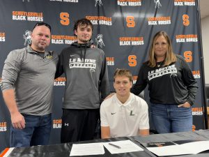 Ollie Bolduc with his parents and brother during his Division One signing.